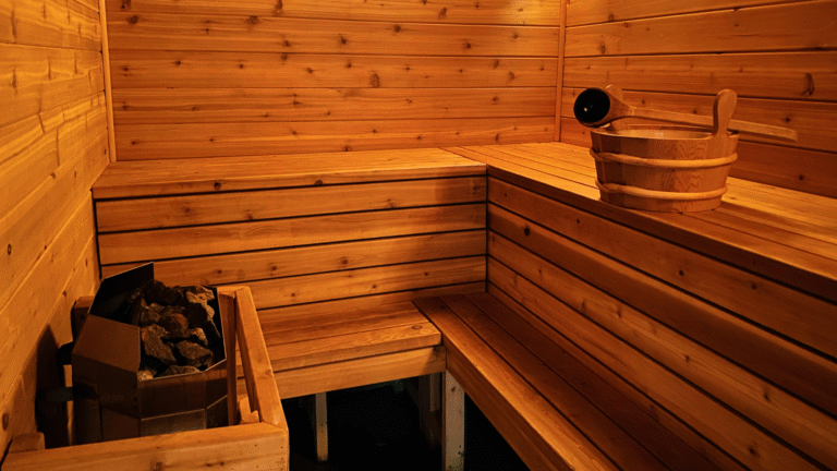 Interior of modern infrared sauna with warm red glow and wooden benches